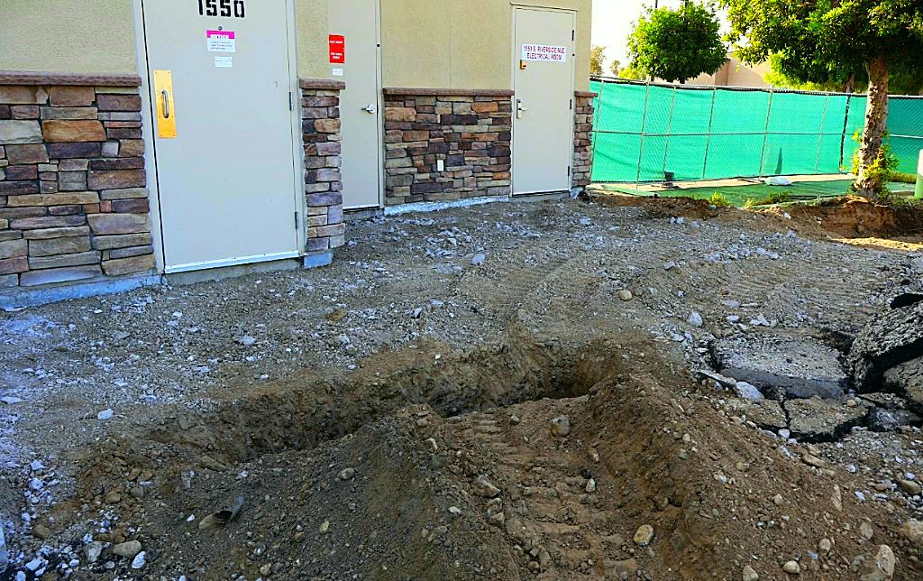 Utility trench excavation outside a building electrical room