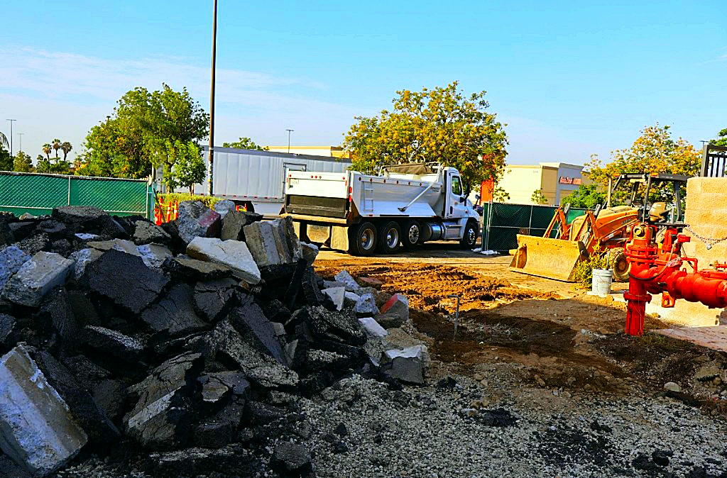 Saw-cut asphalt and concrete demo staged for haul-off