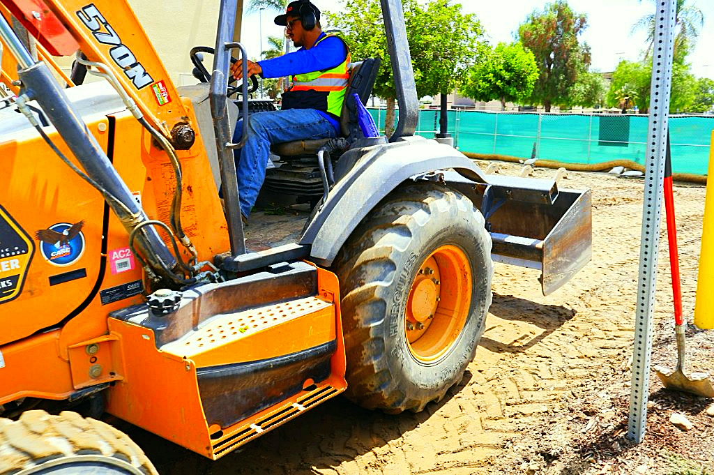 Mendozer operator running a Case 570N skip loader
